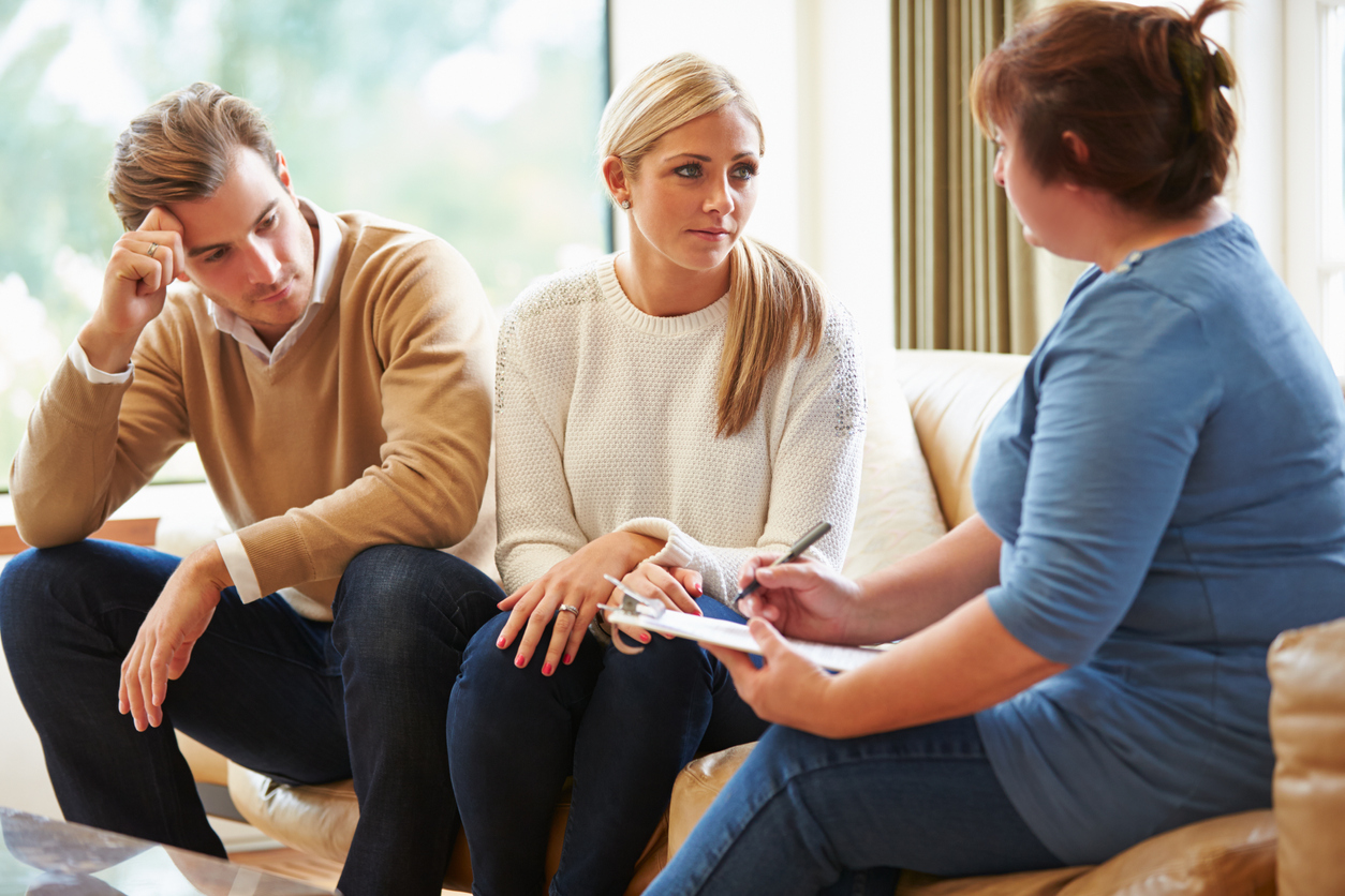 Counselor Advising Upset & Stressed Couple On Relationship Difficulties
